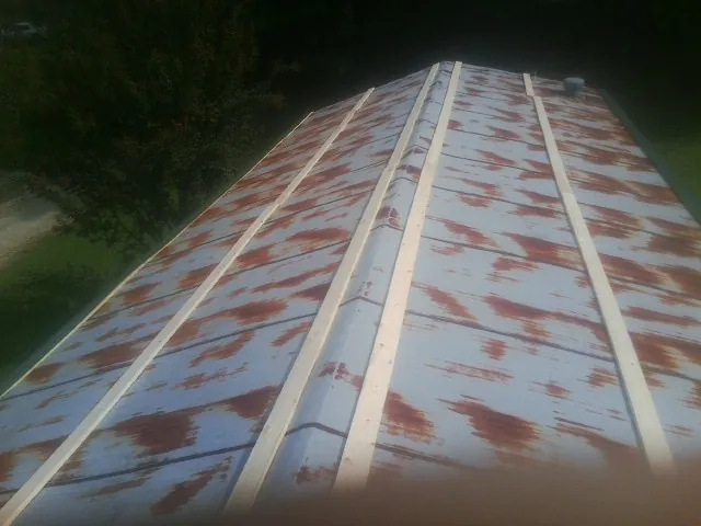 Rusted metal roof panels with new wood purlins before replacement — Storm Damage Roof Repair in White Bird by Roofing Brothers